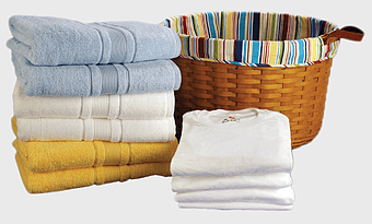 brown woven laundry basket, folded towels, laundry room essentials, self-service laundry, laundry organization ideas, clean home textiles, laundry storage solutions